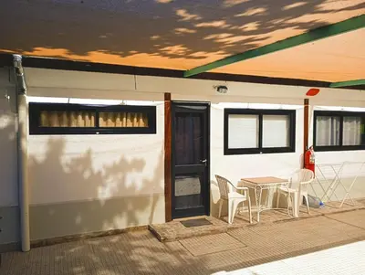 a patio with a table and chairs next to a building at Mina's Apart in Mina Clavero