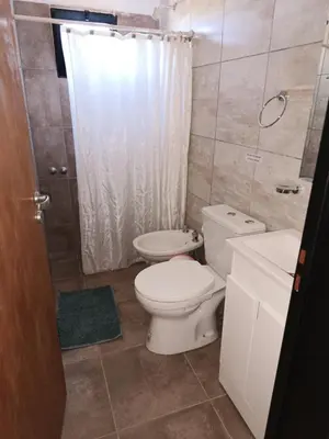 a bathroom with a toilet and a sink at Complejo Barranca Poceña in Quebrada de los Pozos