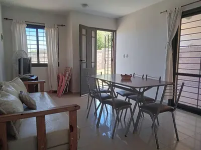 a dining room with a table and chairs at Mi Chalet Carlos Paz - Dúplex in Villa Santa Cruz del Lago