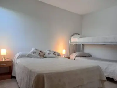 a bedroom with two beds and two lamps at Mi Chalet Carlos Paz - Dúplex in Villa Santa Cruz del Lago