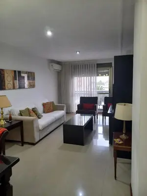 a living room with a couch and a table at MC departamento in Río Cuarto