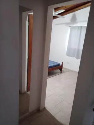 a hallway with a doorway to a room with a bench at Mi Recreo in Villa Cura Brochero