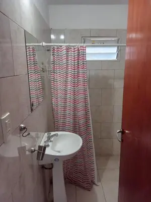 a bathroom with a sink and a shower curtain at Mi Recreo in Villa Cura Brochero