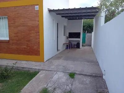 an empty garage with awning next to a building at Mi Recreo in Villa Cura Brochero