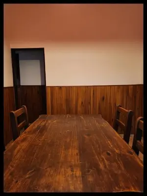 a large wooden table in a room with chairs at Casa Q a 5km del centro de Villa Carlos Paz in Villa Santa Cruz del Lago