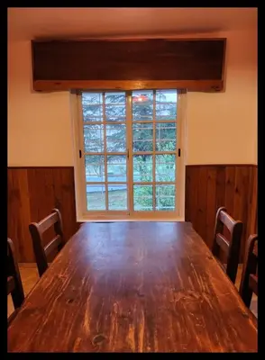 a large wooden table in a room with a window at Casa Q a 5km del centro de Villa Carlos Paz in Villa Santa Cruz del Lago