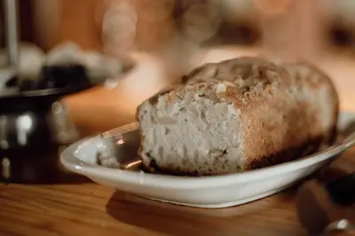 a loaf of bread sitting on a plate on a table at Cantonavi Cabañas in Mina Clavero