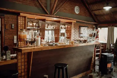 a bar in a room with a brick wall at Cantonavi Cabañas in Mina Clavero