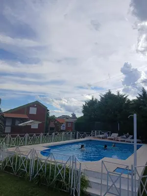 a large swimming pool with people in it at Cantonavi Cabañas in Mina Clavero