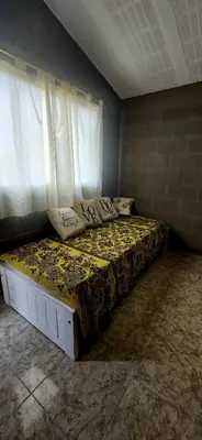 a bed sitting in a room with a window at CASA SEN in Mina Clavero