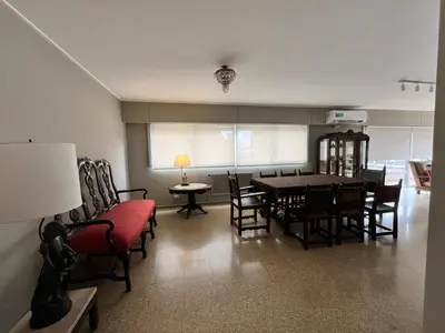 a living room with a dining room table and chairs at Dpto amplio y luminoso en Nva Cordoba in Cordoba