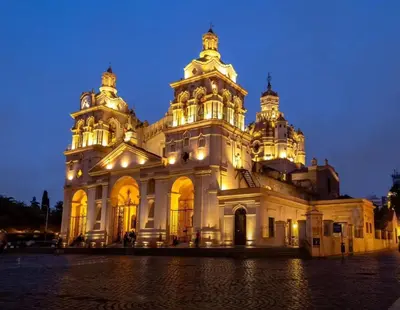 a large white building with lights on it at night at Dpto amplio y luminoso en Nva Cordoba in Cordoba