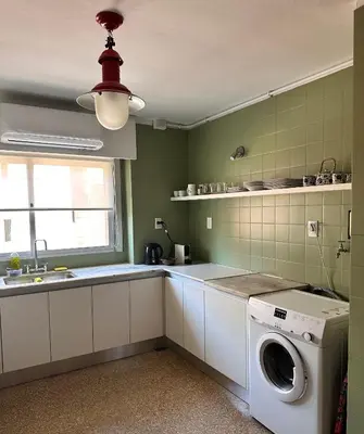 a kitchen with a washing machine and a window at Dpto amplio y luminoso en Nva Cordoba in Cordoba