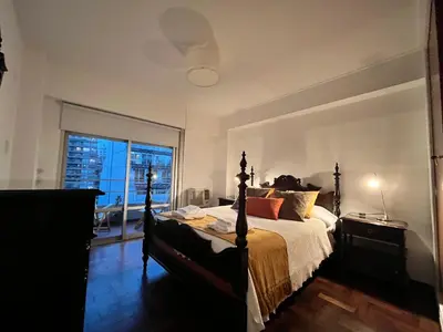 a bedroom with a bed and a large window at Dpto amplio y luminoso en Nva Cordoba in Cordoba