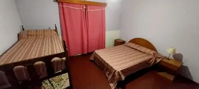 a room with two beds and a red curtain at ARROYO SERRANO-MINA CLAVERO in Mina Clavero