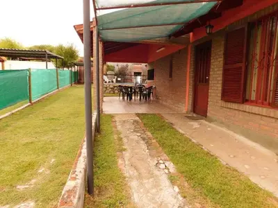 a house with an awning on the side of it at Dúplex PIRULO in Villa Cura Brochero