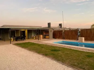 a house with a swimming pool in front of it at Palmares - Casas Anisacate in Villa Anizacate
