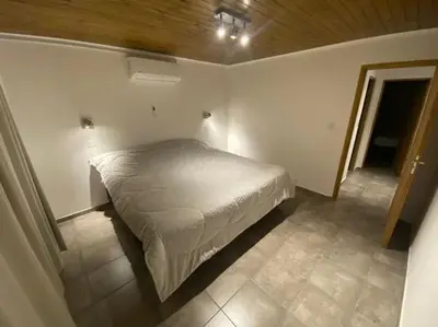 a small bedroom with a bed in a room at Palmares - Casas Anisacate in Villa Anizacate