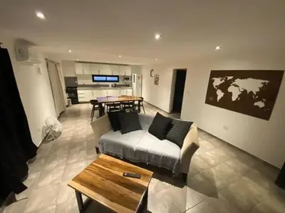 a living room with a couch and a table at Palmares - Casas Anisacate in Villa Anizacate