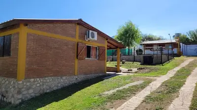 a brick building with a window on the side of it at Mi Recreo CABAÑAS in Villa Cura Brochero