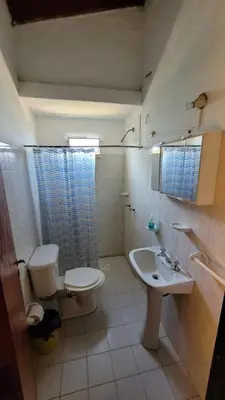 a bathroom with a toilet and a sink at Mi Recreo CABAÑAS in Villa Cura Brochero