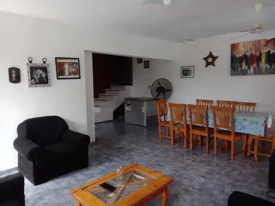 a living room with a table and a dining room at Mi Chalet Carlos Paz - Casa 18 in Villa Santa Cruz del Lago