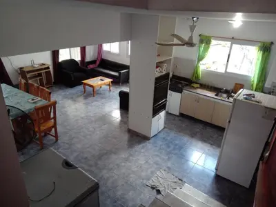 a view of a kitchen and a living room at Mi Chalet Carlos Paz - Casa 18 in Villa Santa Cruz del Lago