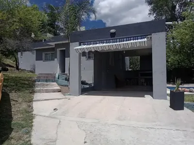 a house with an awning in front of it at Mi Chalet Carlos Paz - Casa 18 in Villa Santa Cruz del Lago