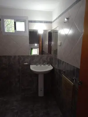 a bathroom with a sink and a mirror at Mi Chalet Carlos Paz - Casa 18 in Villa Santa Cruz del Lago