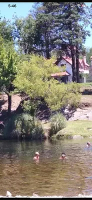 three people swimming in the water in a lake at Apartamento Remansum in Santa Rosa de Calamuchita