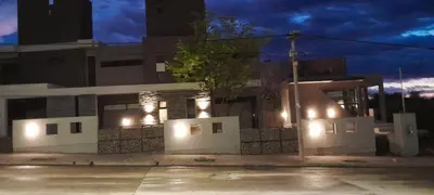 a building with lights on the side of it at night at Acacias Mina Clavero in Mina Clavero