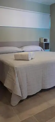 a bedroom with a bed with two towels on it at Acacias Mina Clavero in Mina Clavero