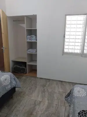 a bedroom with a bed and a window at El espinillo in Villa Carlos Paz