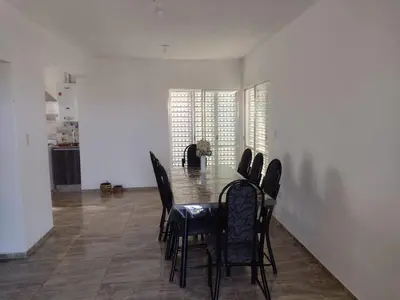 a dining room with a table and chairs at El espinillo in Villa Carlos Paz