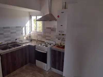 a kitchen with a stove and a sink at El espinillo in Villa Carlos Paz