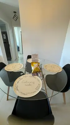 a table with two chairs and a bottle on it at Guesthouse Luxury in Cordoba