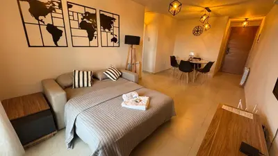a bedroom with a bed and a couch and a table at Guesthouse Luxury in Cordoba