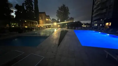 an empty swimming pool at night with lights at Guesthouse Luxury in Cordoba