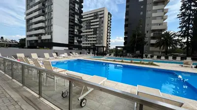 a large swimming pool with chairs and buildings at Guesthouse Luxury in Cordoba