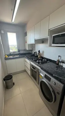a kitchen with a stove and a washer and dryer at Guesthouse Luxury in Cordoba
