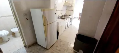 a kitchen with a white refrigerator and a sink at Lo de Liliana 1 in Tanti