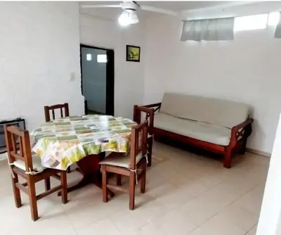 a room with a table and chairs and a bed at Lo de Liliana 1 in Tanti