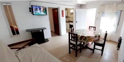 a living room with a table and chairs and a couch at Lo de Liliana 1 in Tanti