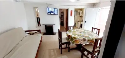 a room with a table and chairs and a kitchen at Lo de Liliana 1 in Tanti