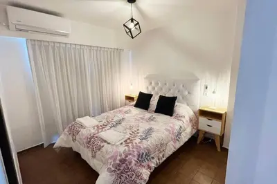 a bedroom with a large bed and two night stands at Departamento en la mejor zona de Nueva Córdoba in Cordoba