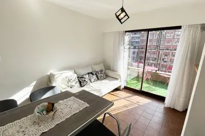 a living room with a couch and a table at Departamento en la mejor zona de Nueva Córdoba in Cordoba