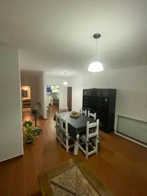 a living room with a table and chairs in it at departamento céntrico in Villa Carlos Paz
