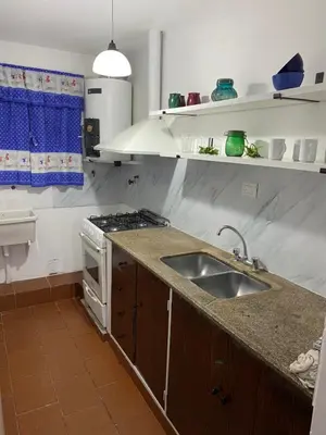 a kitchen with a sink and a stove at departamento céntrico in Villa Carlos Paz