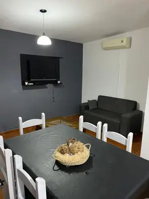 a living room with a table and a couch at departamento céntrico in Villa Carlos Paz
