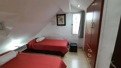a small room with two beds and a window at Casa con piscina vista al lago montañas-Sierras de Córdoba in Villa Parque Siquiman